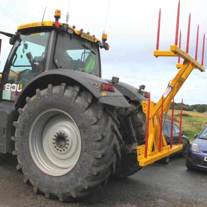 Hydraulically folding Big Bale Transporter for the back of tractors.